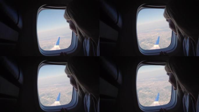 一个女人乘飞机旅行，看着窗外
