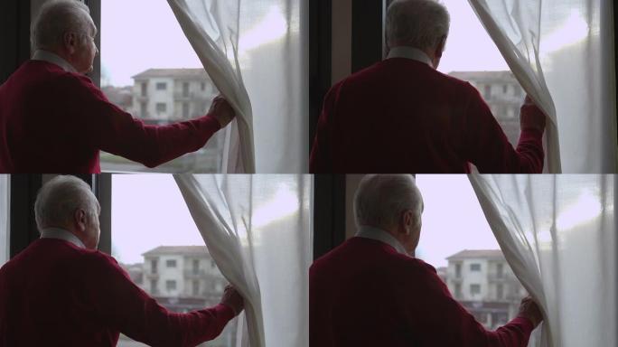 忧心忡忡的老人移动窗帘，看着窗外
