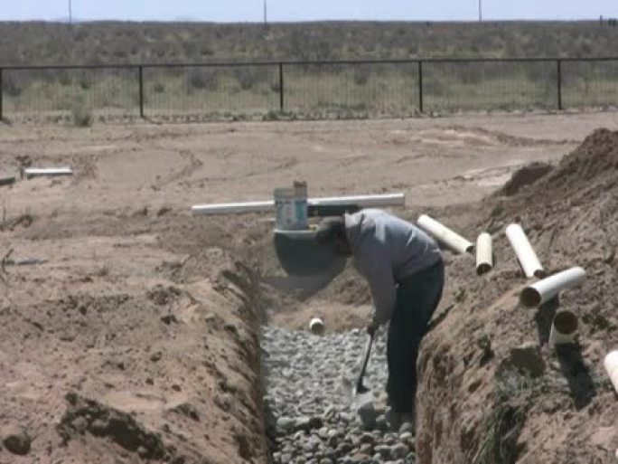 NTSC: 工人在排水场平整石块以进行化粪池