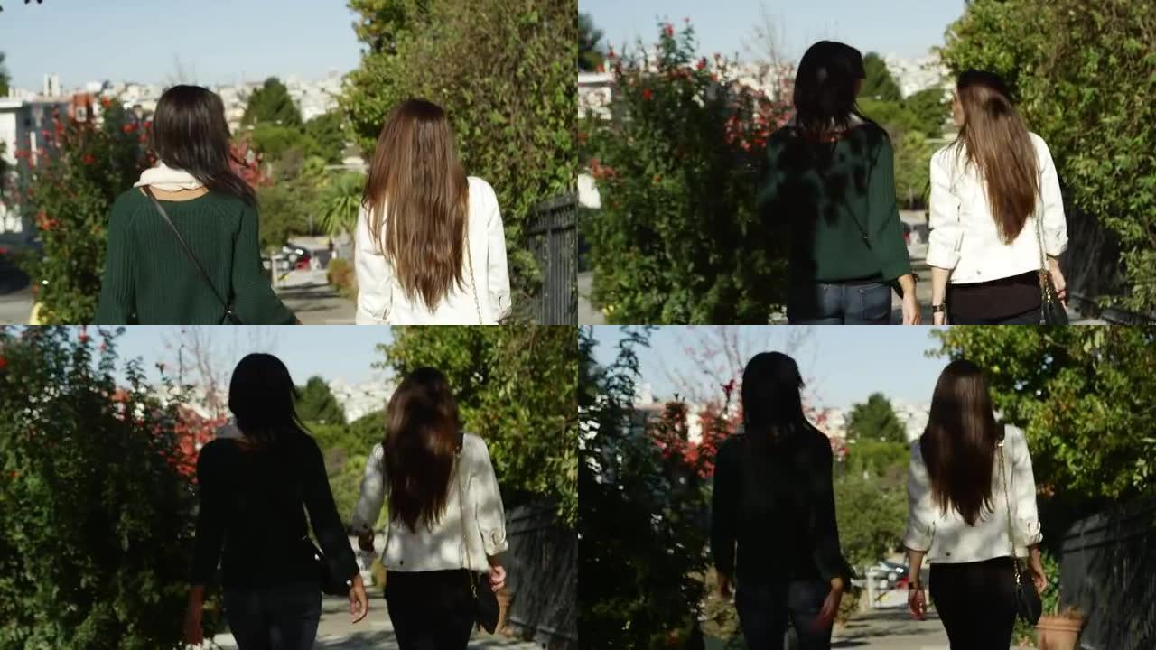 镜头跟随两个女孩在白天慢动作从山上走下来。