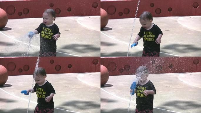 慢动作 -- 可爱的蹒跚学步的孩子在喷泉里玩耍