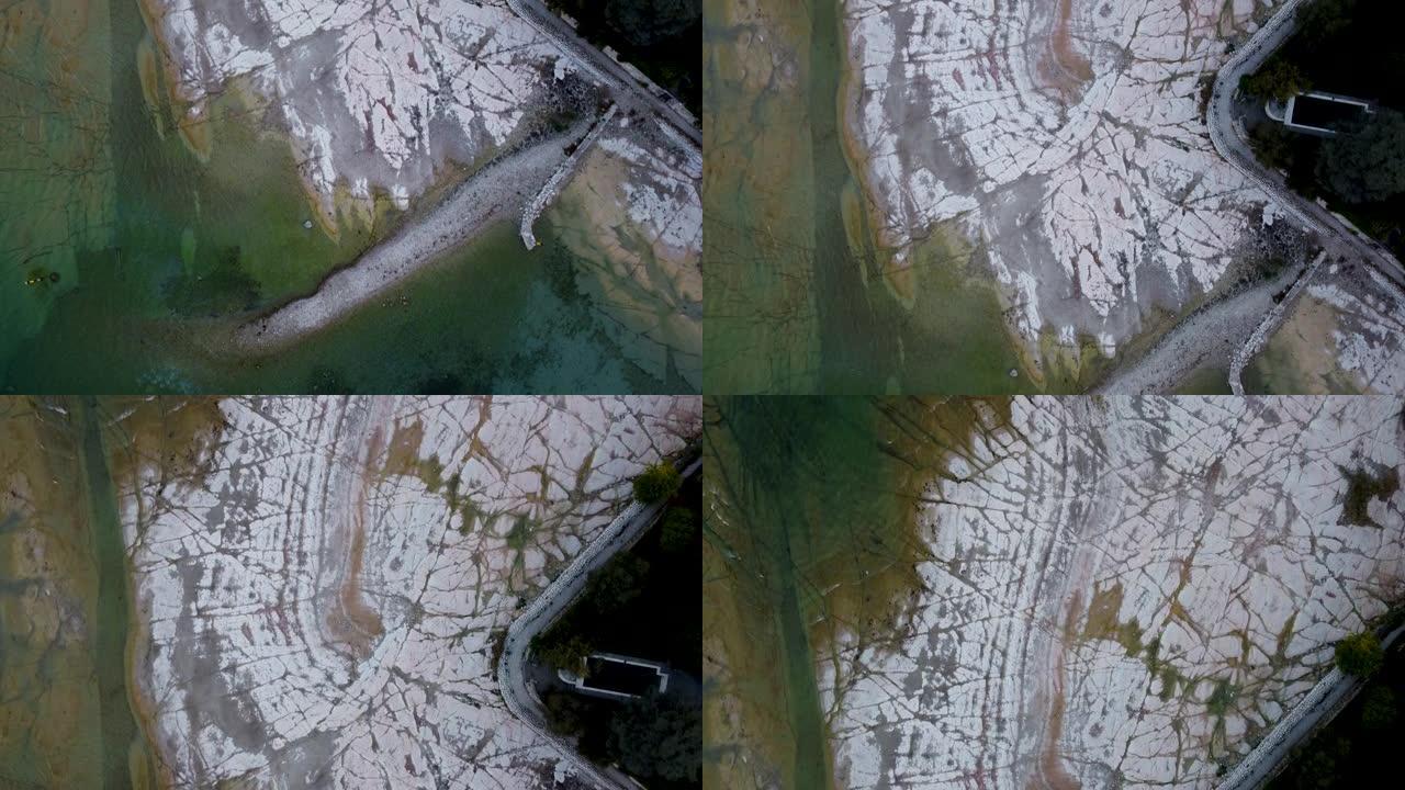 在意大利贝拉焦 (Bellagio) 崎rock不平的岩石湖海岸上的无人机视图