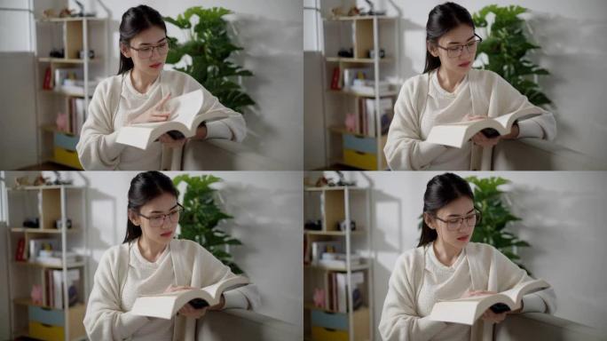 亚洲年轻女子在家客厅阅读教科书