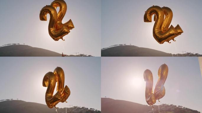 22号日落时分，生日派对金色气球漂浮在阳光明媚的屋顶上