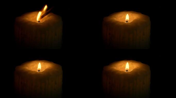 在黑暗中点燃一根大蜡烛并吹灭
