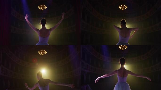 年轻优雅的古典芭蕾舞女舞者以戏剧性的灯光进入经典剧院的舞台的电影背景图。专业女表演者演出前独自排练