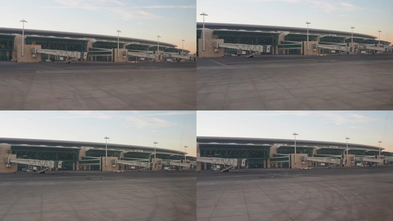 从沿机场移动的飞机的窗户上射击。安卡拉Esenboga Havalimani机场的航站楼和建筑物。国