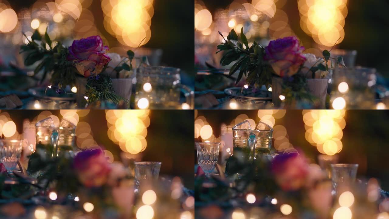 用玫瑰花装饰的浪漫餐桌，晚上用蜡烛灯庆祝情人节概念4k