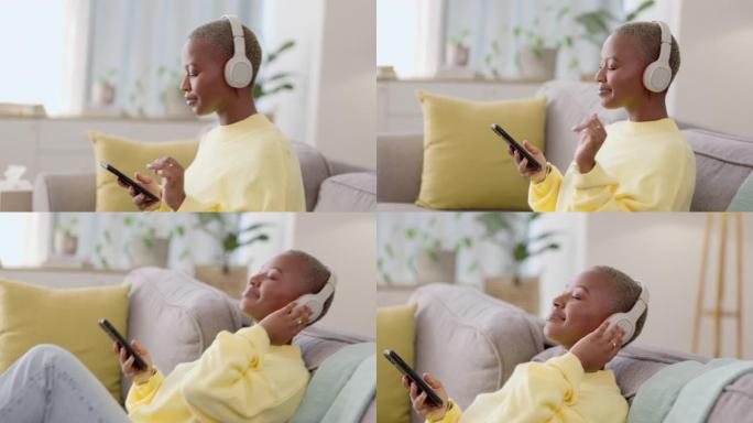 沙发上的黑人妇女，耳机和智能手机，可在休息室进行连接，放松和流媒体音乐。非裔美国女性，女士和带耳机的