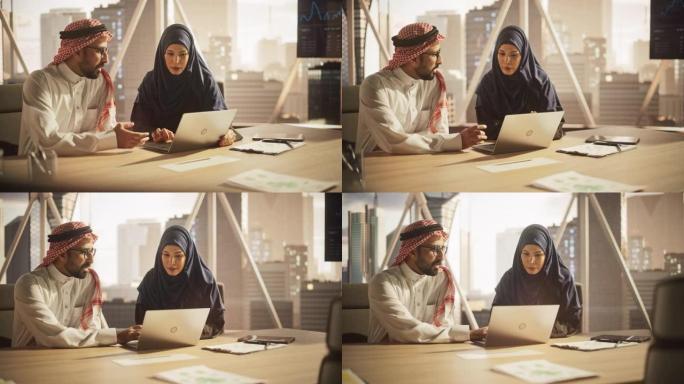 阿拉伯金融分析师开会与一位女性团队负责人讨论一个项目。中东同事使用笔记本电脑，在现代办公室工作，戴着