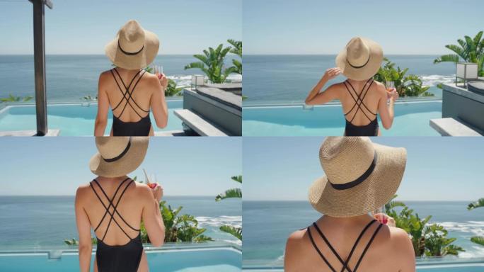 旅行的女人走在游泳池在豪华酒店度假与美丽的海景喝鸡尾酒享受享受异国情调的暑假穿着性感的比基尼4k
