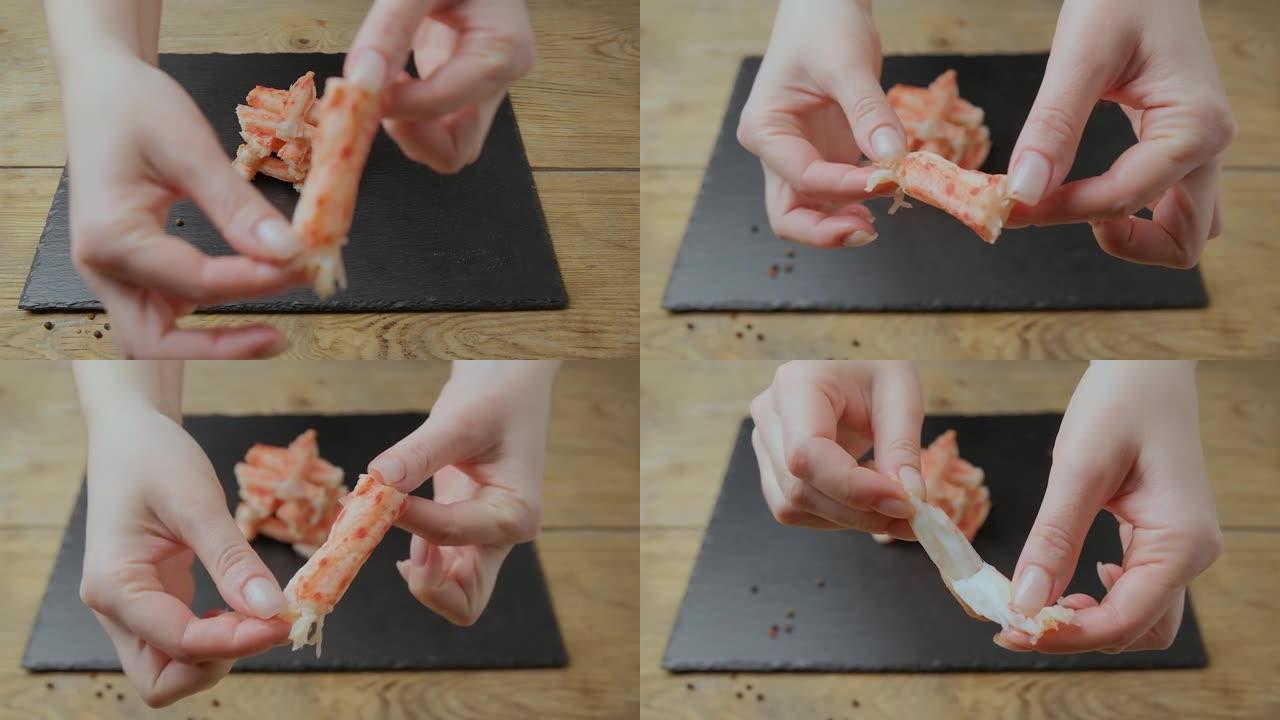 女孩用手拿一块蟹肉，对着镜头看。
