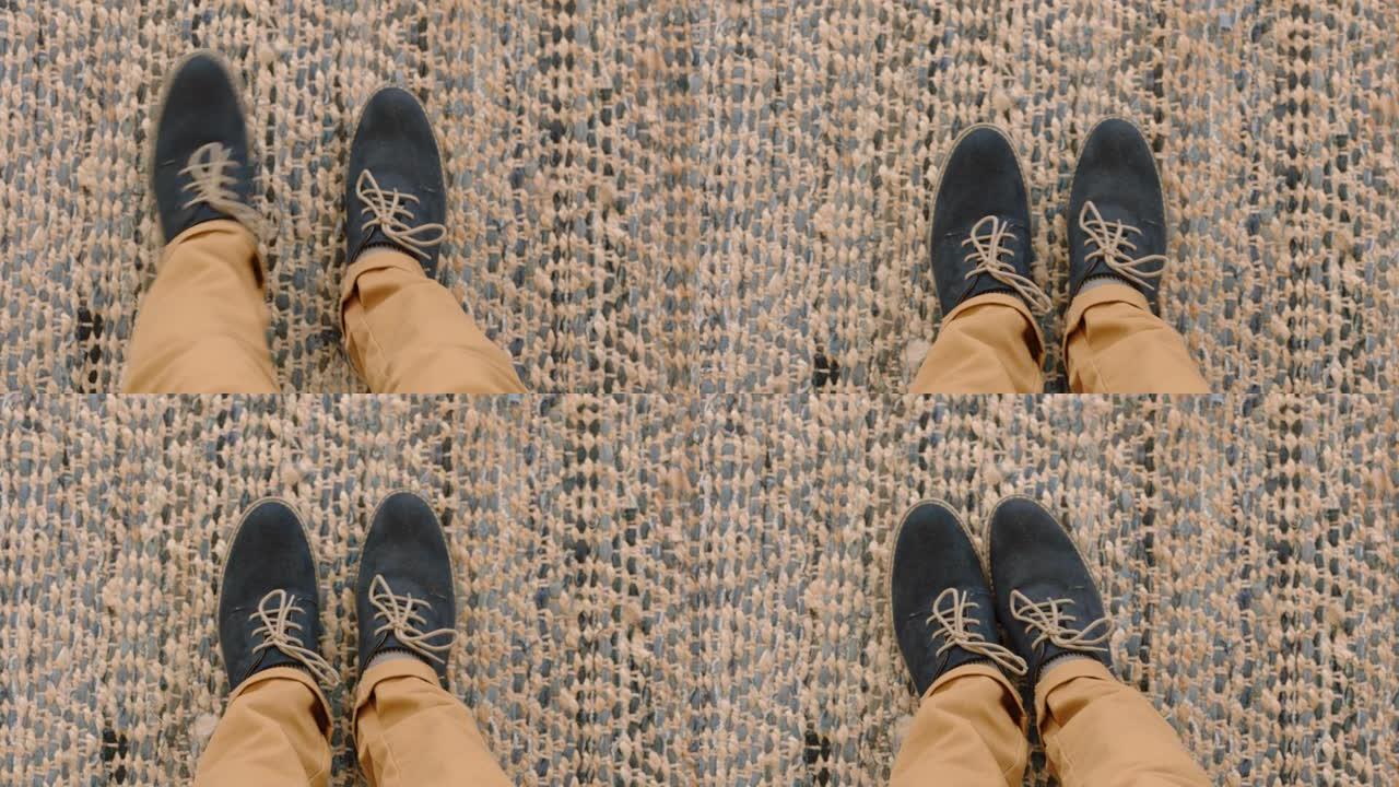 顶视图男人穿着鞋子，站在地毯上享受时尚的脚