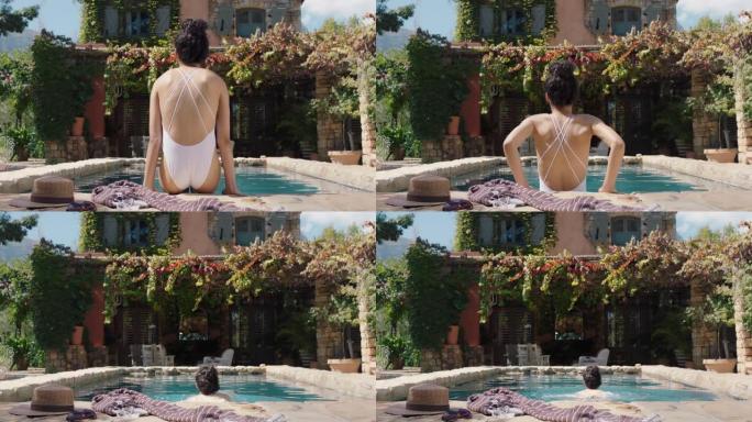 性感的女人在美丽的假日别墅游泳池游泳，享受晒日光浴华丽的女游客暑假穿着比基尼4k镜头