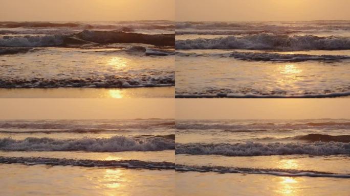 日出时海岸上海浪的特写。慢动作观看镜头
