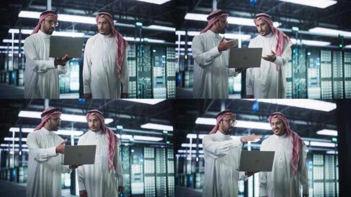 中东计算机工程师和网络安全专家在服务器机房工作，与笔记本电脑交谈，进行系统维护检查。在数据中心做数据