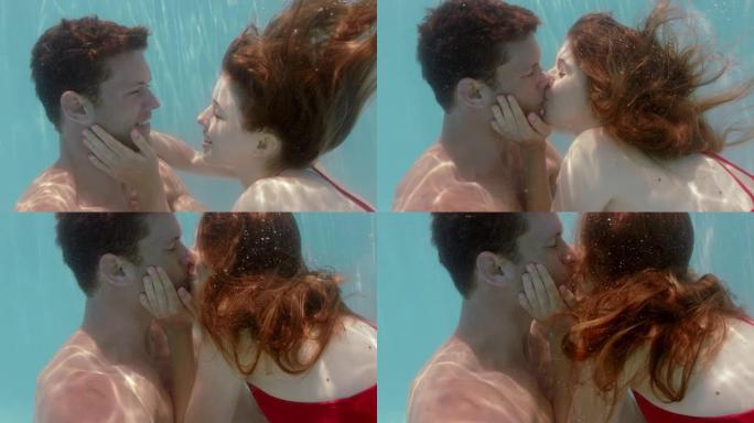 浪漫的情侣在游泳池水下接吻诱人的女人与漂浮在水中的年轻人亲热，带着泡泡分享亲密的吻夏季浪漫4k