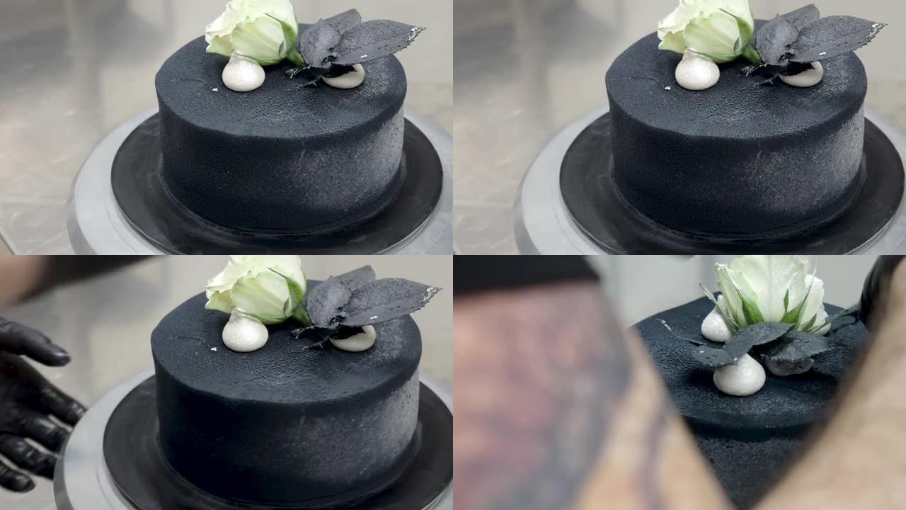 厨师顶部黑色喷枪涂磨砂糖霜蛋糕顶部两个真正的玫瑰银喷和可食用的巧克力头骨，卡拉维拉主题muertos