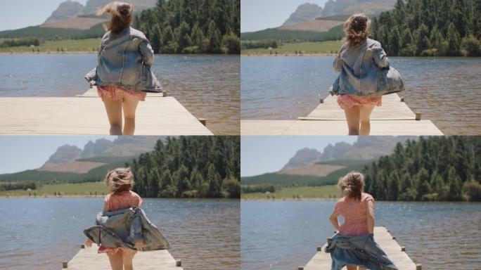 冒险女人在码头上奔跑，脱掉衣服，准备跳进湖里享受夏天的自由
