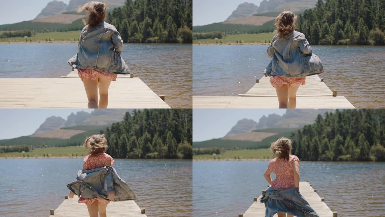 冒险女人在码头上奔跑，脱掉衣服，准备跳进湖里享受夏天的自由