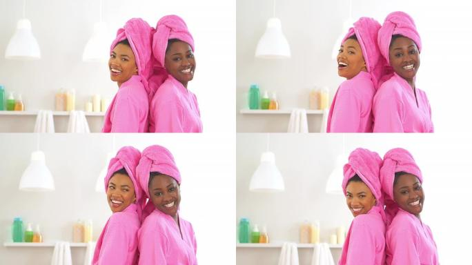 两个穿着长袍在水疗中心微笑的非洲裔美国朋友
