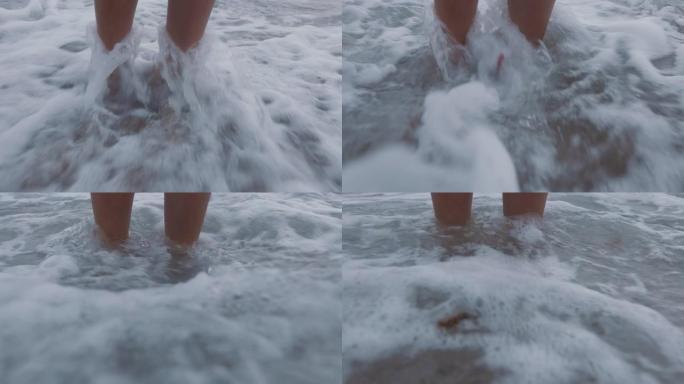 近脚浪飞溅赤脚女子站在海滩上享受清新的海洋海滨度假