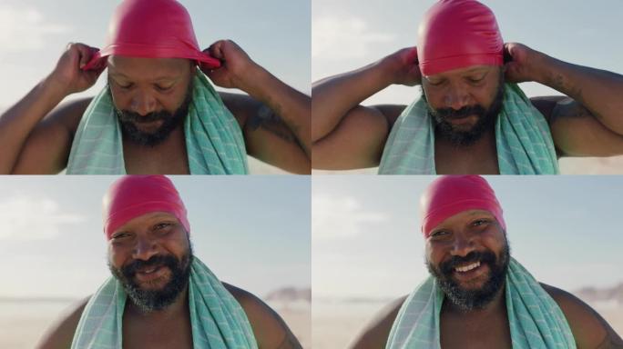 肖像快乐的非洲裔美国男子戴着游泳帽在海滩上享受美丽的海滨早晨准备游泳4k镜头