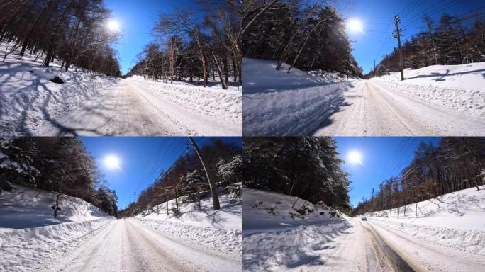 在冬季山区积雪覆盖的道路上行驶。驶向太阳