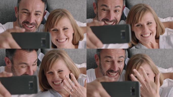 快乐情侣在智能手机上聊天美女展示订婚戒指享受浪漫庆祝