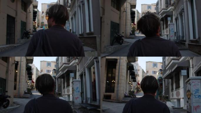 一个年轻人走在伊斯坦布尔的一条街道上，街上有历史建筑，人行道，狭窄的街道。赶时髦的人急着约会，工作在