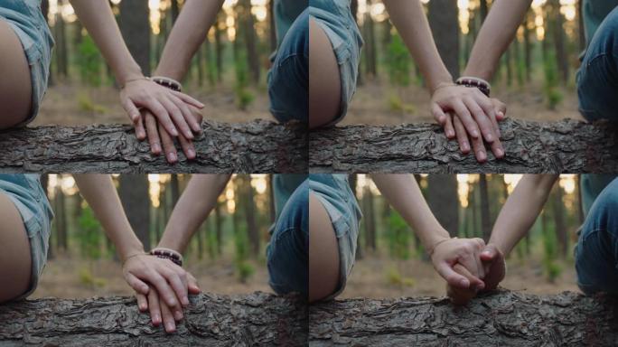 情侣牵手坐在森林里的男朋友和女朋友在森林里分享浪漫的联系快乐的年轻恋人