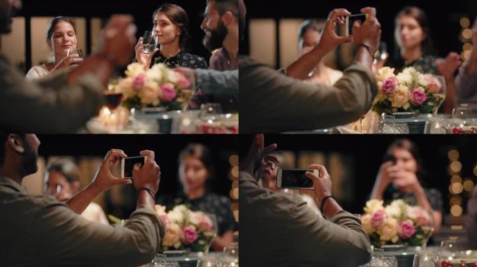 美丽的年轻女性朋友享受晚宴庆祝友谊与朋友拍照使用智能手机分享社交媒体4k上的realxing晚间聚会