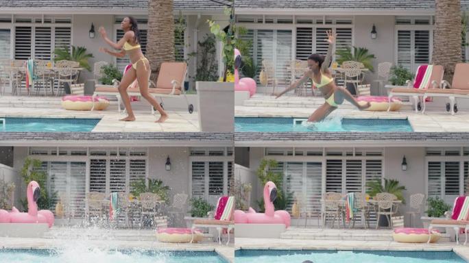 快乐的非洲裔美国妇女跳进游泳池嬉戏玩得开心暑假享受夏天穿着黄色比基尼4k镜头