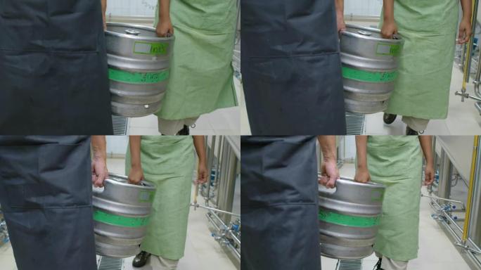 啤酒厂携带重型小桶的匿名男女工人