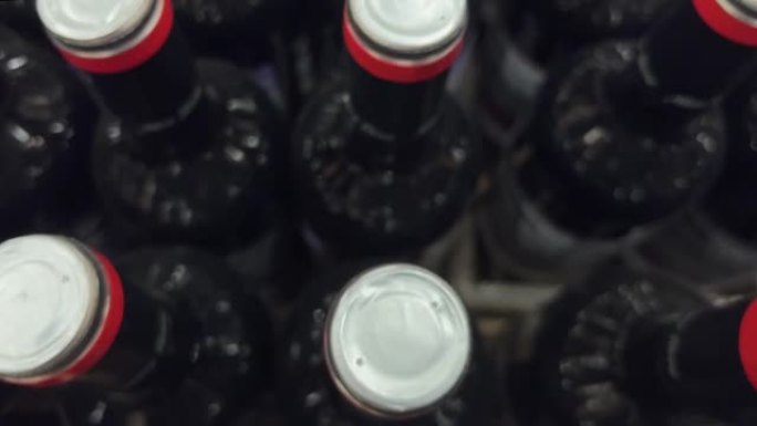 在酒类商店或超市中，成排的红色和白色酒瓶站在托盘上
