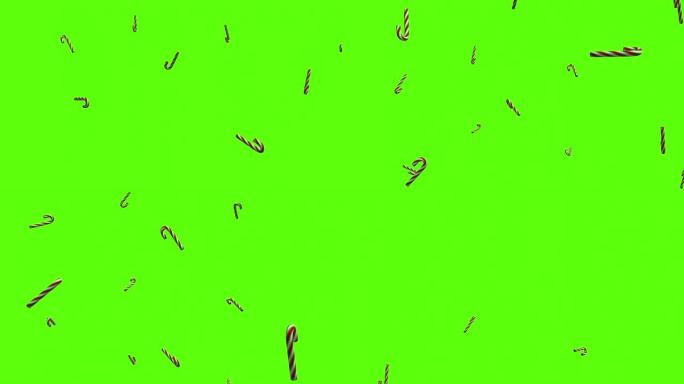 糖果手杖背景。掉落在绿色屏幕或色度键上的糖果棒。屏幕上的甘蔗雨。
