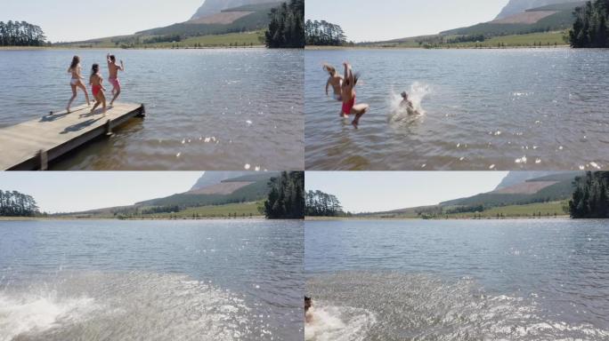 鸟瞰图快乐的朋友在湖边跳下码头，玩得开心，在暑假享受自由，头顶无人机