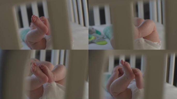 在婴儿床中近距离拍摄小男孩的腿