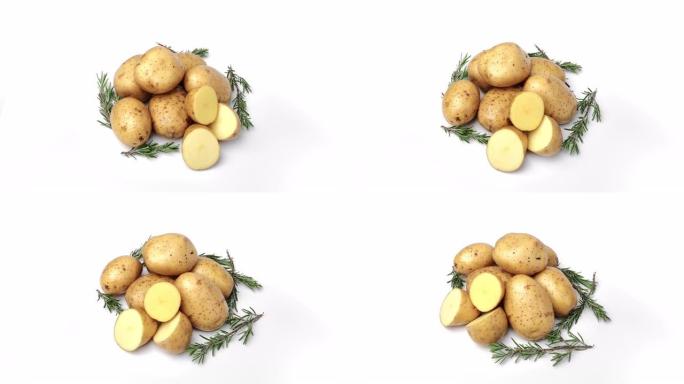 生鲜时令土豆堆整块和半块在果皮中，迷迭香草药轮作分离