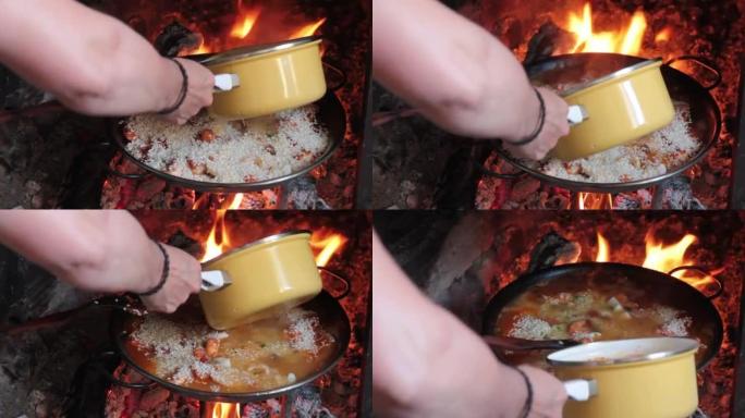 烹饪西班牙海鲜饭-在火上烹饪