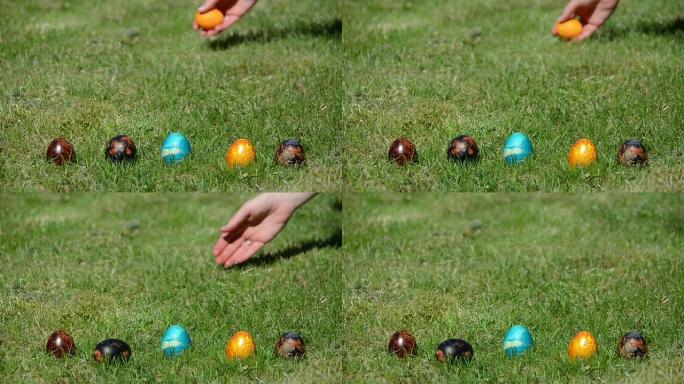 用手把五颜六色的鸡蛋扔在草地上。传统复活节游戏