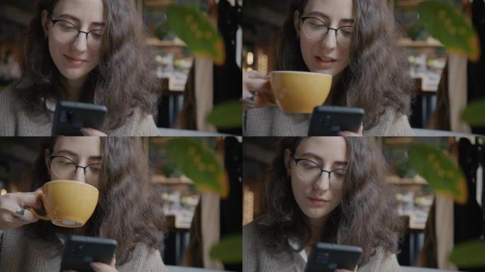 在现代咖啡馆使用智能手机和喝咖啡的开朗年轻女士的肖像