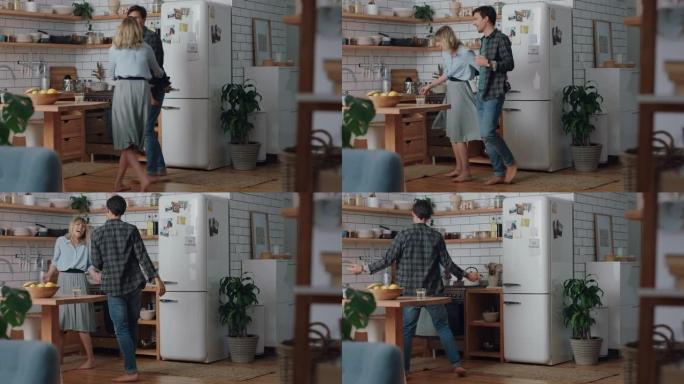 快乐的年轻夫妇在厨房跳舞，庆祝一起跳舞，享受有趣的浪漫关系，在家4k镜头