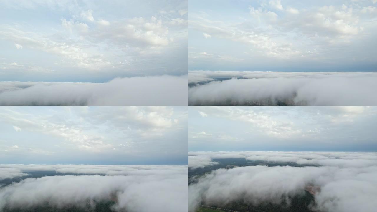 白云蓝天风景鸟瞰图移动。晚上，在明亮的太阳日落雾中，无人驾驶飞机在蓝天中飞出蓬松的云层。自然