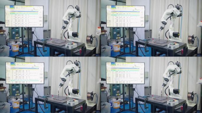 员工正在通过遥控器操作焊接机器人，他们穿着安全服，安全帽和安全镜，在焊接车间工作，高级员工在工作区域