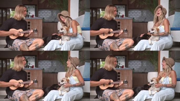 相爱的情侣唱歌。快乐的人弹四弦琴吉他。恋人约会。宠物狗。