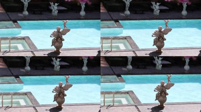 希腊的丘比特雕塑装饰着游泳池。雕塑和希腊风格的装饰品