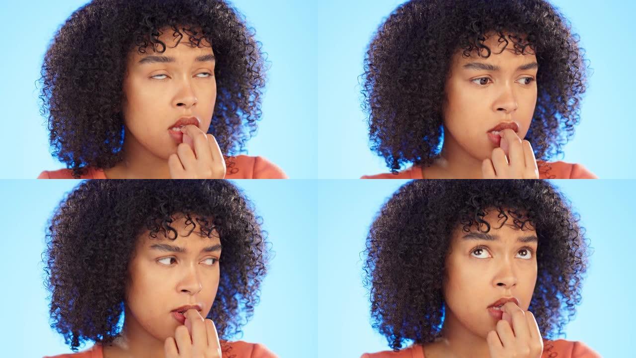 黑人妇女咬指甲，焦虑和紧张的脸，精神卫生和恐惧孤立在蓝色背景上。女性害怕，在工作室里思考危机或压力和