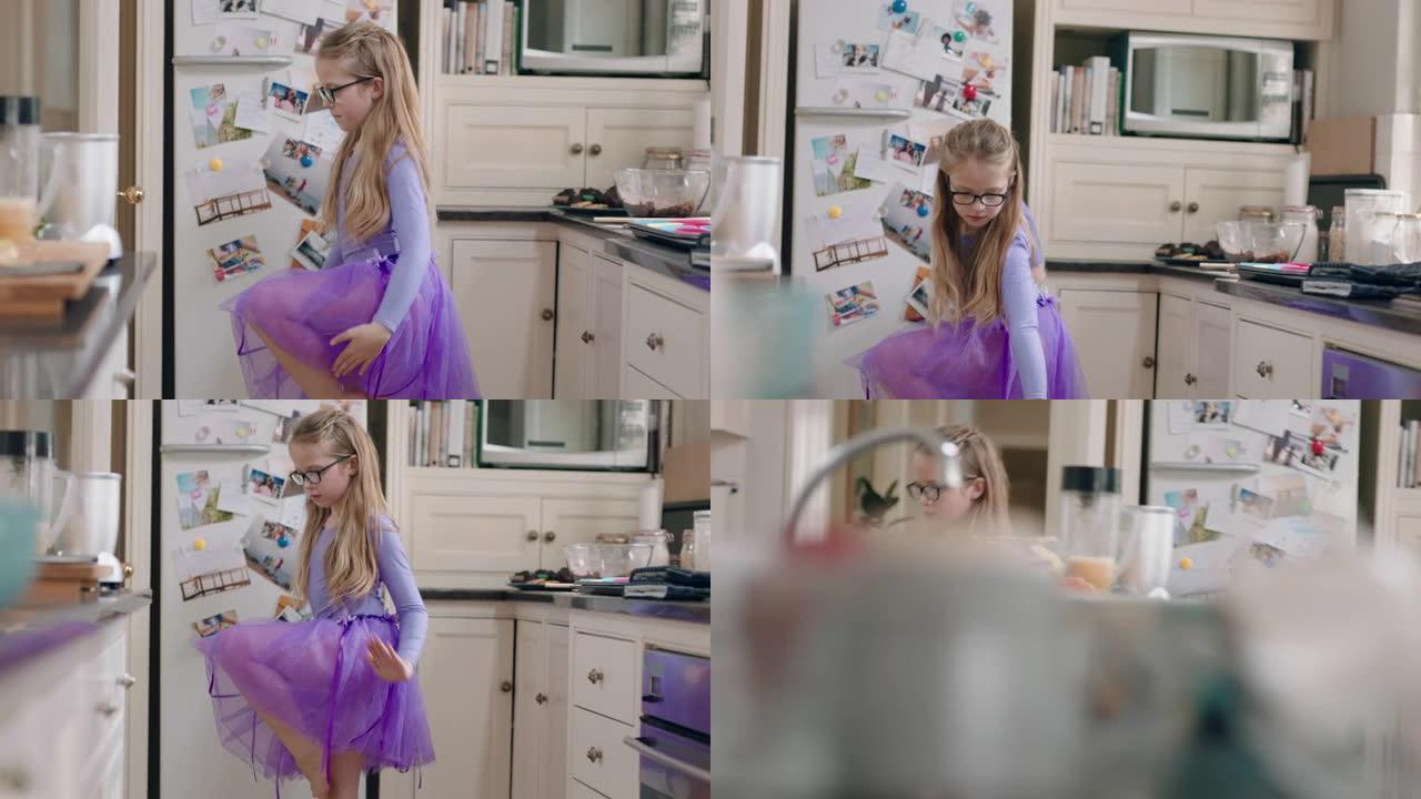 快乐的芭蕾舞女演员在厨房跳舞，在家穿着紫色短裙练习芭蕾舞动作很开心