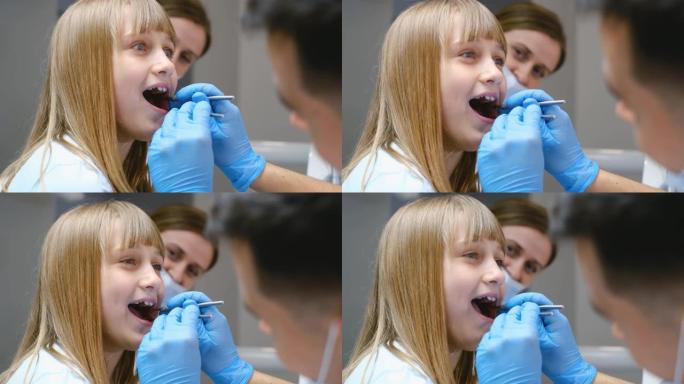 漂亮的小女孩在牙医的预约，牙科检查，龋齿。